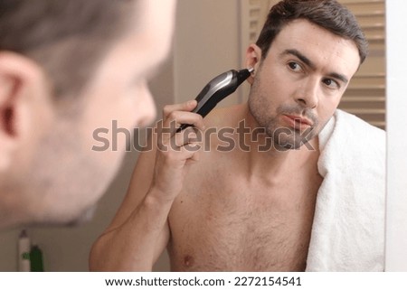 Man trimming his ear hairs