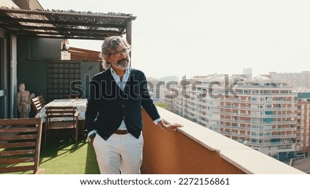 Senier enjoys the view standing on the balcony