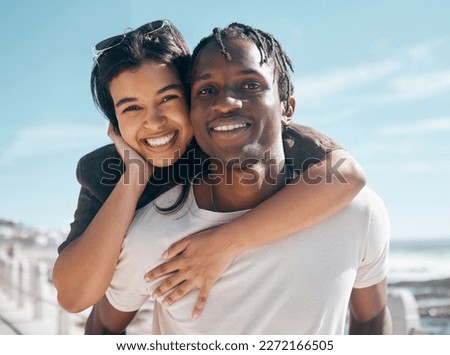 Happy couple, portrait and piggyback by beach in relax romance holiday, love vacation date or summer travel location. Smile, bonding and man carrying black woman in fun game, freedom trust or support