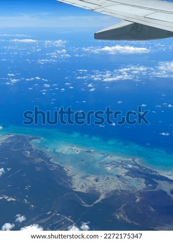 Beautiful View of Caribbean Island from above. Mix of colors blue, green and turquoise in the ocean. Concept for vacation, traveler, freedom.