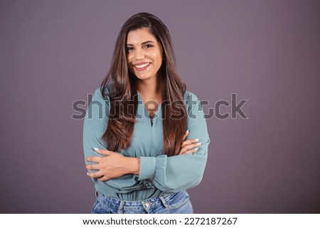 Horizontal photo. Beautiful Brazilian woman, with casual clothes, Jeans and green shirt. with arms crossed. Royalty-Free Stock Photo #2272187267