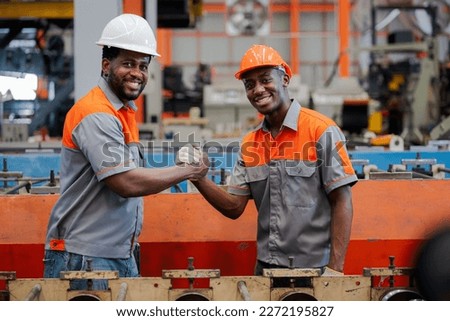 Smart portraits, African Americans engineers and technician workers  are giving a confident thumbs-up within a standardized industry. Royalty-Free Stock Photo #2272195827