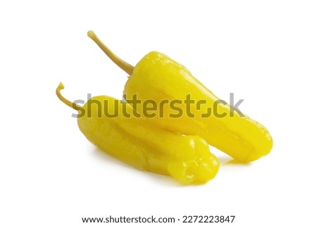 Two pickled yellow peppers, pepperoncini or friggitelli isolated on white background. Hot pepper marinated, brined. Traditional Italian and greek cuisine, ingredient for salad, pasta, sauce. Royalty-Free Stock Photo #2272223847