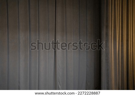 Massive monochromatic curtain of fabric in the theater