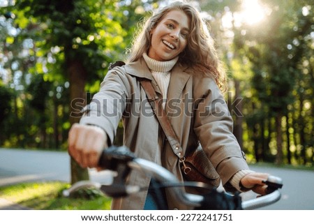 Beautiful woman  riding bicycle in  park. Lifestyle. Relax, nature concept. Spring time.