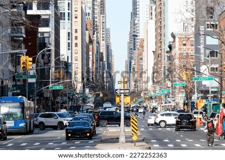 Busy street view with people, cars and buses in the crowded intersections on 3rd Avenue in the East Village neighborhood of New York City NYC Royalty-Free Stock Photo #2272252363