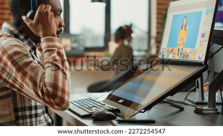 Graphic designer expert editing pictures on touchscreen monitor, using tablet and stylus pen in studio office. Male photographer creating multimedia content with retouching software.