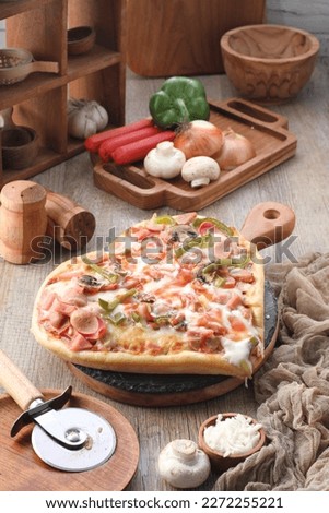 Pizza is a dish of Italian origin consisting of a usually round, flat base of leavened wheat-based dough topped with tomatoes, cheese, and often various other ingredients