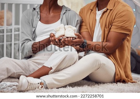 Pregnant, baby shoes and black couple hands to start a new family on bedroom floor. Man and woman together excited about pregnancy future, love and life insurance for health and support in their home Royalty-Free Stock Photo #2272258701