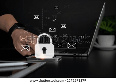 Male finger touching smartphone lock icon, business technology.Protect a cyber security from hacker attacks and save clients confidential data.Padlock Hologram icons over the typing hands. Royalty-Free Stock Photo #2272291379