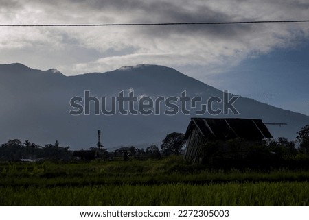 view of a wooden hut with a mountain in the background