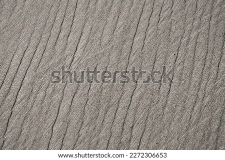 gray sand patterned with regular stripes