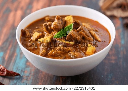 Spicy beef curry. Goan style beef vindaloo. Traditional Indian Lamb or beef curry. spicy gravy popular in Kerala Sri Lankan Goa for Appam Parotta porotta in India. Royalty-Free Stock Photo #2272315401