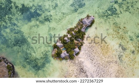 The turquoise ocean water and the luxurious resort on Kiwengwa beach in Zanzibar, Tanzania, are captured in this gorgeous toned aerial view. The scenery is simply stunning, and it's a perfect destinat