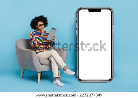 Full length photo of boss curly hairdo lady hold tablet near banner wear eyewear shirt jeans shoes isolated on blue background