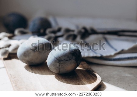 Sprigs Painted Easter eggs and on a linen tablecloth, marble eggs. Eco.Trend. Copy space