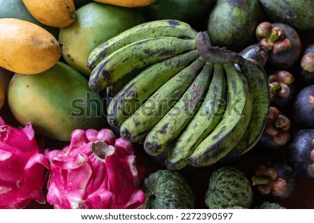 Set of Balinese fruits and vegetables. Banana, dragon fruit, mango, mangosteen, avocado. Flat lay