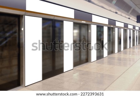 Perspective view of mockup of multiple blank banners, posters, in generic train station; advertising space templates; OOH mock up. Straight front view of MRT platform, without people.