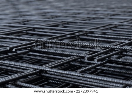 Group of deformed bar or reinforced concrete construction steel net piles on outdoor ground. Selective focus and blurred for copy space. Royalty-Free Stock Photo #2272397941