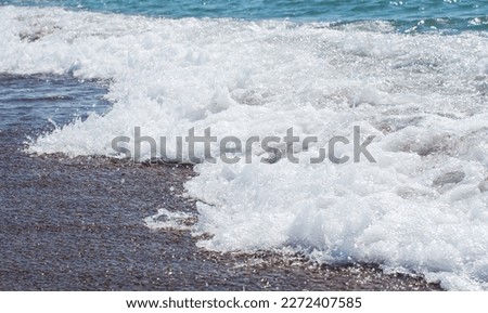 The waves break on the shore. A beautiful spray of sea water.