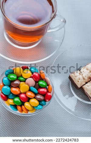 Bowl of candy and a cup of tea.