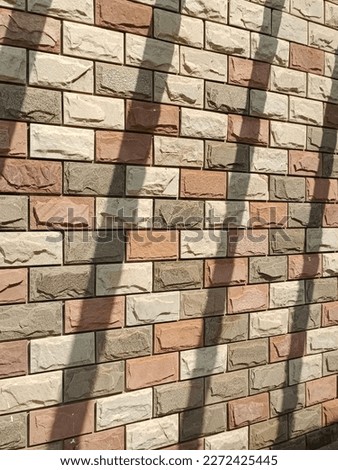 a brown wall with the shadow