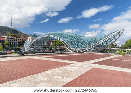 Awesome view of the Bridge of Peace over the Kura (Mtkvari) River in Tbilisi, Georgia. Tbilisi is a popular tourist destination of the Caucasus region. Royalty-Free Stock Photo #2272446965