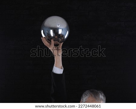 silver ball in businessman hand