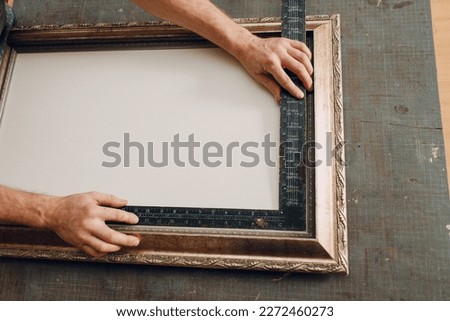 Framing Workshop. Measure ruler frame baguette handmade picture frame at studio table