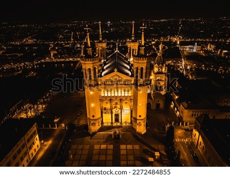 Panoramic aerial shot at night time of illuminated Basilica Notre Dame de Fourviere 