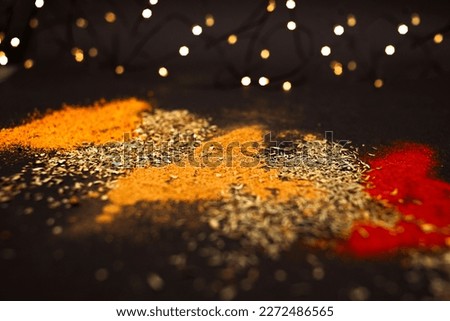 Various spices scattered on a black background. Background picture
