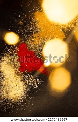 Various spices scattered on a black background. Background picture