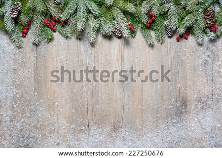 Christmas background with fir tree on old wooden board