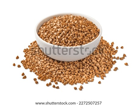 Full buckwheat bowl in the middle of buckwheat pile isolated on white background. Side view. Package design element with clipping path