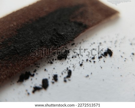 sharpening a pencil with sandpaper. graphite on sandpaper after sharpening a pencil
