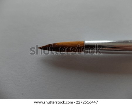 close-up photo of a paint brush on a white background