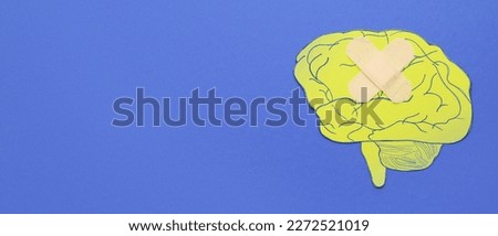 Paper brain and patch on blue background with space for text. Concept of neurology