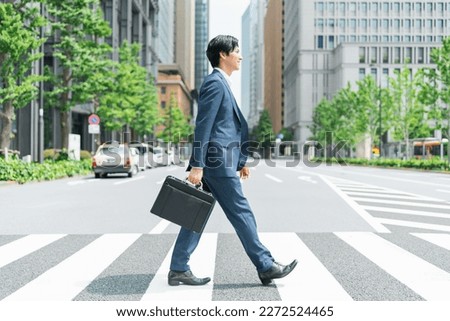 Young Asian businessman working in the business district Royalty-Free Stock Photo #2272524465