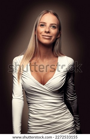 Beautiful fashion portrait of a smiling blonde woman in white dress Royalty-Free Stock Photo #2272533155