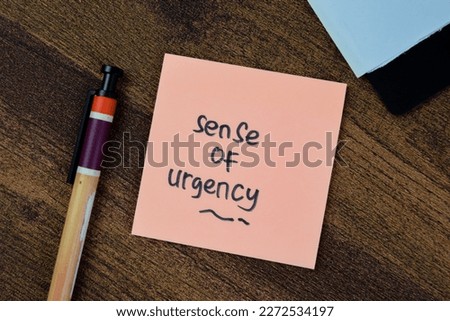 Concept of Sense of Urgency write on sticky notes isolated on Wooden Table. Royalty-Free Stock Photo #2272534197