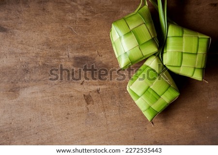 Close up view of Ketupat, an Indonesian traditional cuisine very popular during Hari Raya Idul Fitri. It is a natural rice casing made from young coconut leaves for cooking rice. Royalty-Free Stock Photo #2272535443