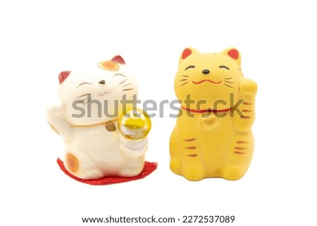 Two Maneki-neko money cats or prosperity cats isolated on white background  is a symbol of good luck, prosperity and good fortune. Royalty-Free Stock Photo #2272537089
