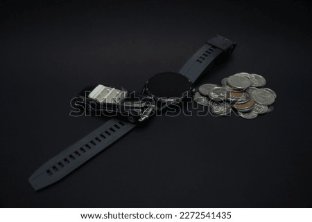 Concept for wealthiness and financial planning. A photo of a car, smartwatch, and pile of coins, after some edits.