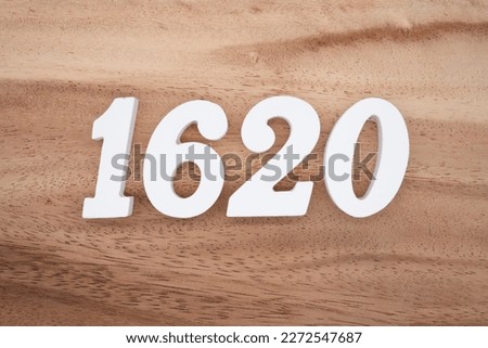 White number 1620 on a brown and light brown wooden background.