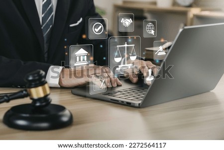 Hand of the businessman or  Lawyer with legal services icon on the laptop screen for Legal advice online in Labor law for a business company legal. concept of legal consultant and lawyer  Royalty-Free Stock Photo #2272564117