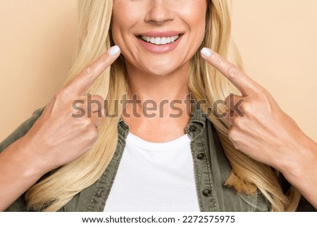 Cropped photo of pretty adorable woman wear khaki shirt pointing two fingers white teeth isolated beige color background Royalty-Free Stock Photo #2272575975