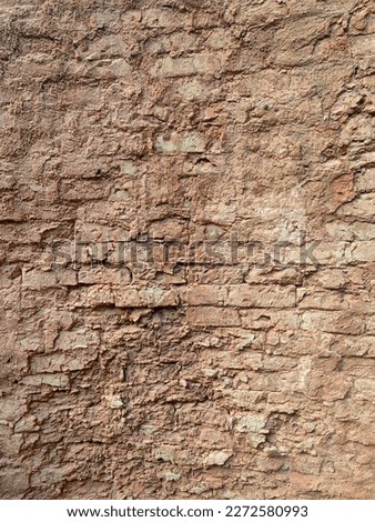 Red old-fashioned stone wall or brick wall perfectly suitable as background or texture. Rural surface of yellow stone bricks texture background