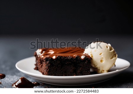 A mouthwatering chocolate brownie in close up macro with vanilla ice cream, dark chocolate sauce, and a black background.