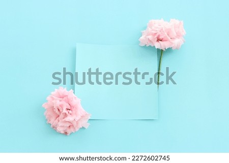 Top view image of delicate lisianthus flower over pastel blue background
