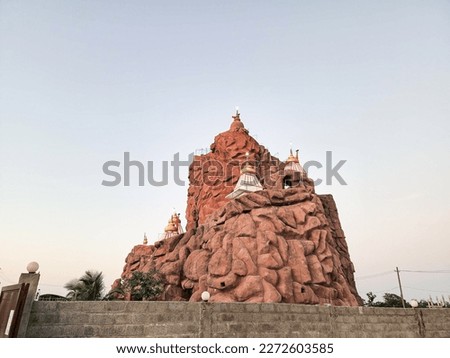 Stock photo of beautiful vaishno devi temple, It looks like a temple on a high hill. temple structure painted by maroon color. Picture captured during beautiful evening at Gulbarga, Karnataka, India.